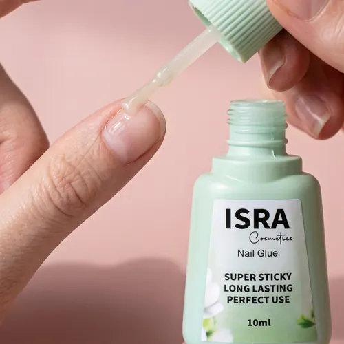 Brushing Isra Nail Glue onto a natural nail